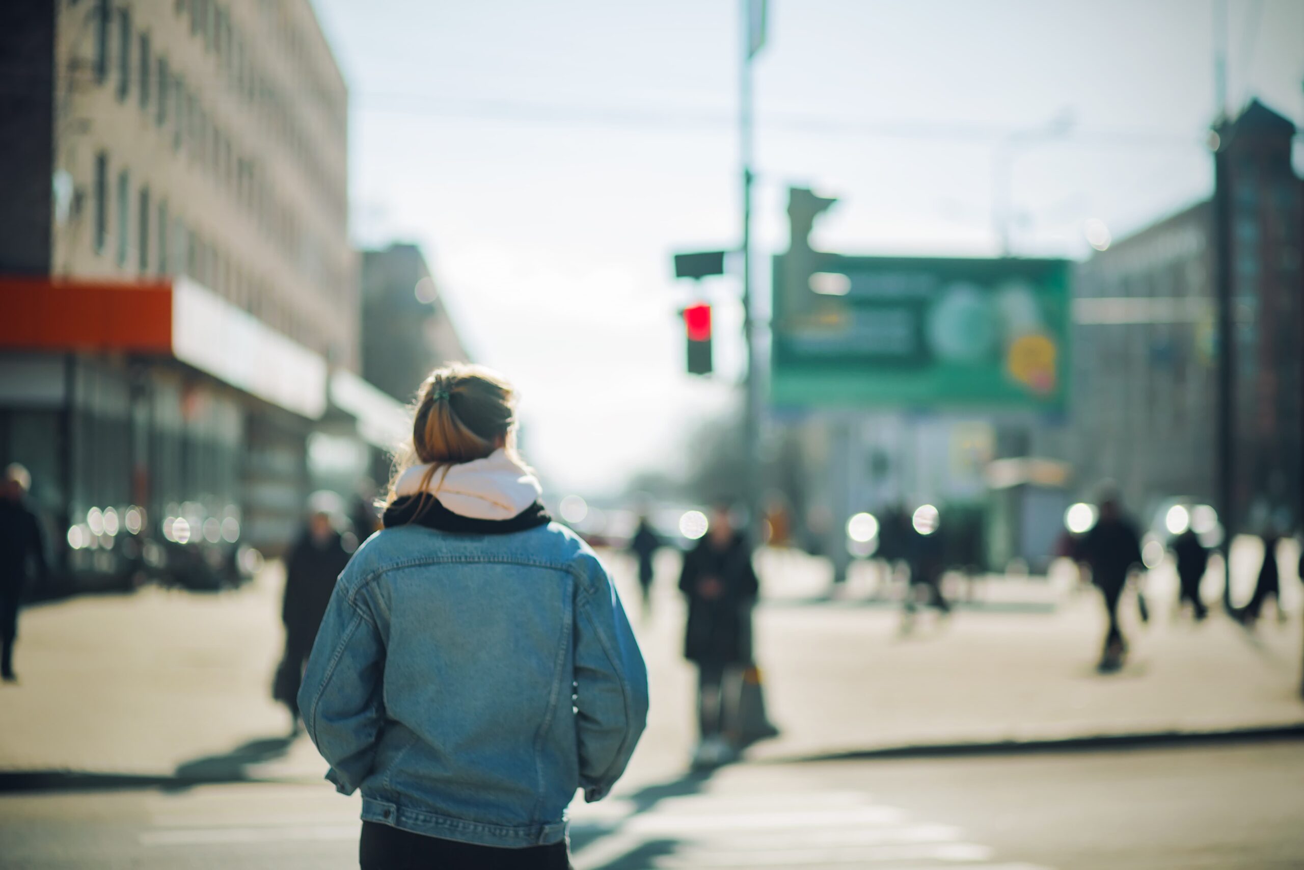 Person pausing at a crosswalk, symbolizing impulse control and addiction recovery