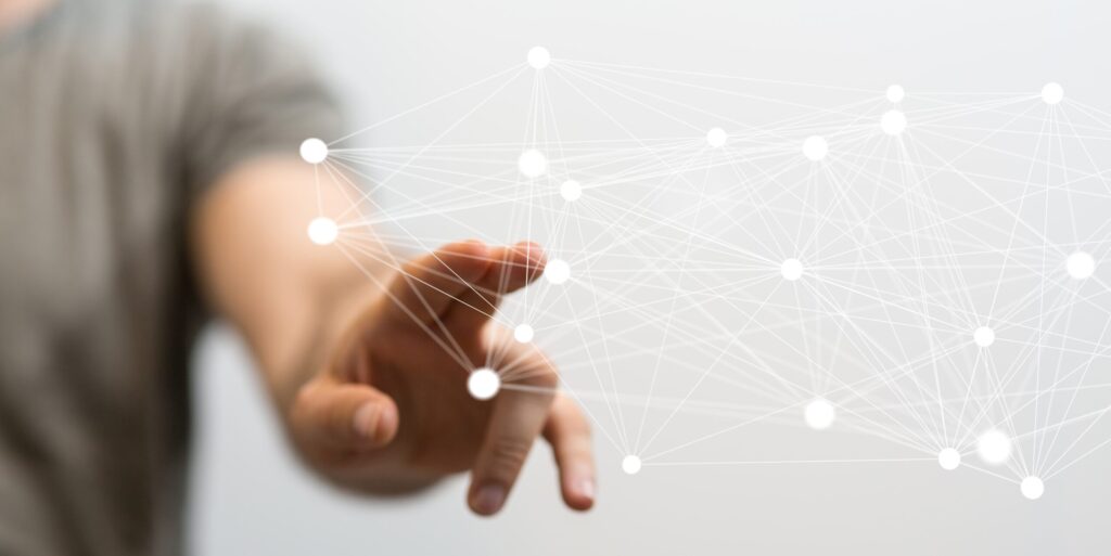 Conceptual image of a human connection (hands) superimposed on a circuit board, symbolizing AI supporting deep therapeutic work at a rehab center